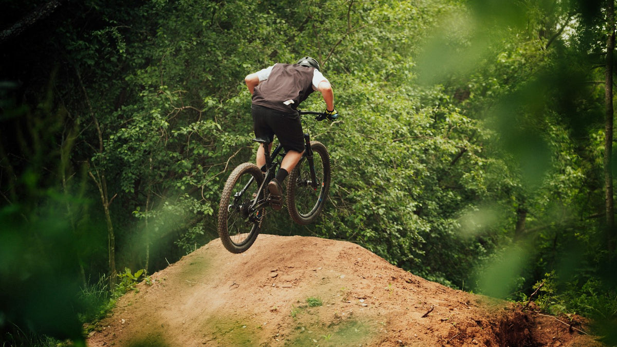 Mountain biker riding a trail bike through rugged terrain